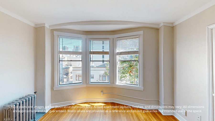 A room with a large window and a radiator on the wall.